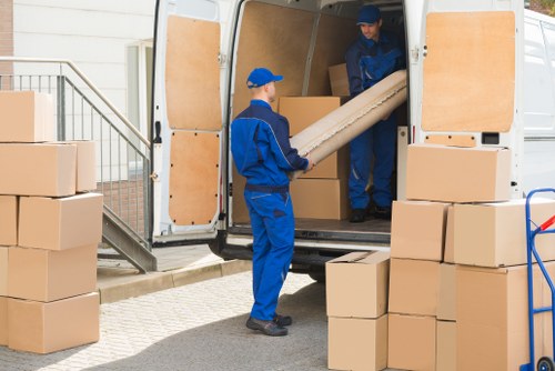 Man and van team loading items near Canary Wharf apartment buildings