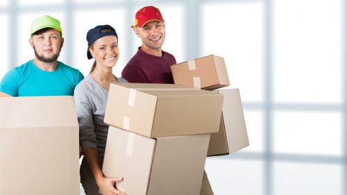 Removal van and movers handling boxes for a local Canary Wharf move