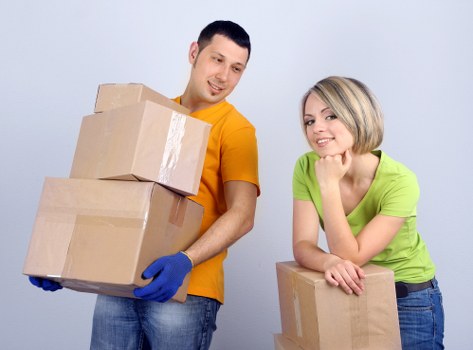 Packed boxes and moving equipment ready for a Canary Wharf relocation