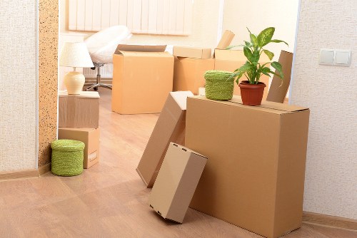 Moving boxes and furniture prepared for a Canary Wharf home relocation