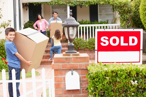 Removalists handling furniture carefully in a modern docklands apartment